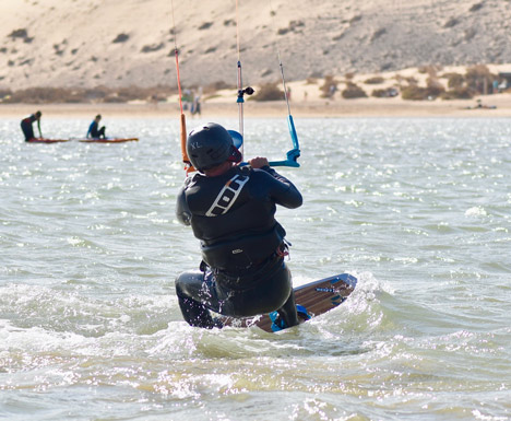 Beginner student of kite surf on his first steps